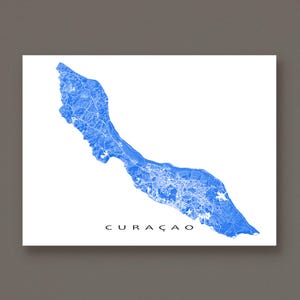 May include: A blue and white map of Curaçao, a Caribbean island, is displayed on a white background. The map highlights the island's topography and infrastructure. The word "CURAÇAO" is printed in black at the bottom of the image.