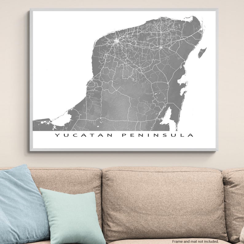 May include: A framed grayscale map print of the Yucatan Peninsula. The map features detailed road networks and geographical features. The text "YUCATAN PENINSULA" is printed in a clean, sans-serif font at the bottom of the print.