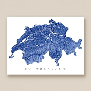 May include: A blue and white topographical map of Switzerland. The map shows the country's terrain with detailed shading and white lines. The word "SWITZERLAND" is printed in black at the bottom of the image.