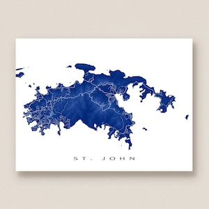May include: A blue and white print of St. John, U.S. Virgin Islands. The map shows the island's shape and topography in shades of blue against a white background. The text "ST. JOHN" is printed in black at the bottom.