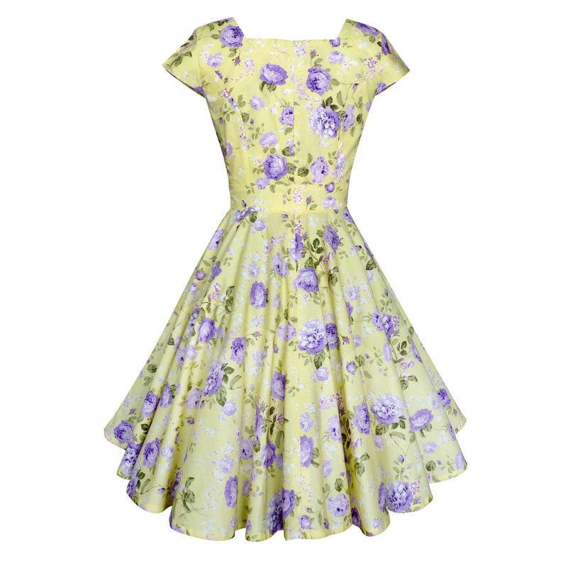 May include: A pale yellow dress featuring a vibrant purple floral pattern with green leaves. The garment has short cap sleeves, a square neckline, a fitted bodice, and a flared, knee-length skirt that creates a full, voluminous silhouette.