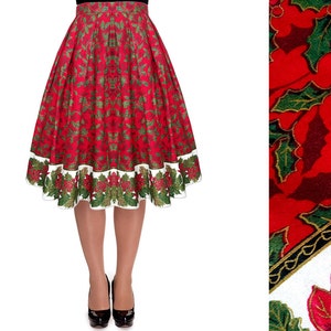 May include: A knee-length pleated skirt featuring a vibrant red background with a repeating pattern of green holly leaves and red berries. The hem is finished with a wide white border decorated with a detailed print of poinsettias and holly.