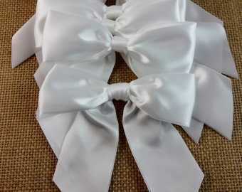 White satin bows, 4.5 inches wide, set of six.  Craft supply for wedding decorations, floral arrangements and DIY projects.
