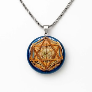 May include: A silver-toned necklace with a round pendant. The pendant features a geometric design in shades of gold and brown, encased in a dark blue resin. The necklace is a stylish accessory.