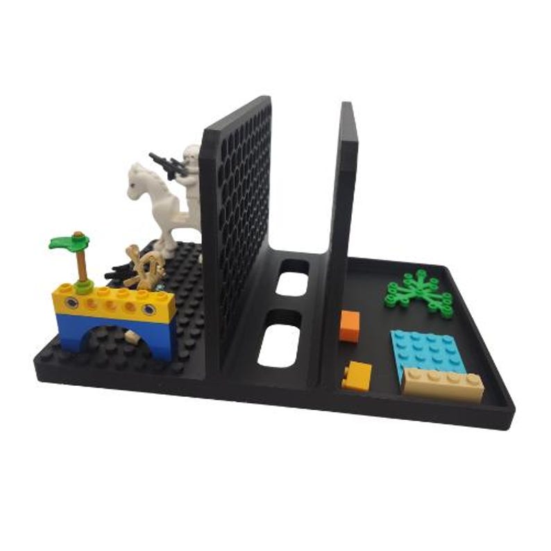 May include: A black plastic organiser with a divided tray and a vertical divider. The organiser holds various colourful toy blocks and a white toy soldier riding a white horse. The blocks include blue, yellow, orange, and green pieces.