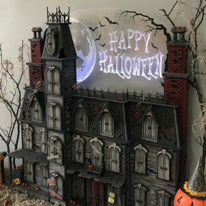 This Halloween Advent Calendar house is hand crafted. It's a spooky Victorian mansion that's sure to amaze you. image 1