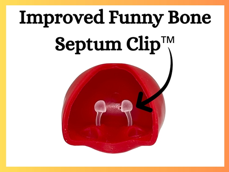 Op de afbeelding: Een rode septumclip met de tekst "Improved Funny Bone Septum Clip&trade;". De clip heeft twee doorzichtige, gebogen pinnen. Het product is ontworpen om in de neus te worden geplaatst.