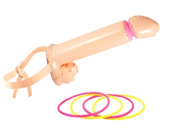 May include: An inflatable novelty toy shaped like a penis, in a flesh tone, with a pink interior. It includes a strap and three colorful rings, pink and yellow, for a game.