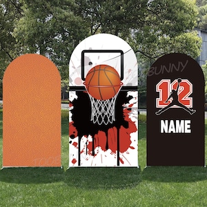 May include: Three basketball-themed yard signs. One is a basketball texture, the second has a basketball going through a hoop with a red and black splatter design, and the third has a jersey design with the number 12 and the word "NAME".