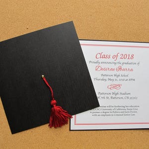 May include: Graduation announcement card with a black cap and tassel. The card is white with red and black text. The text reads "Class of 2018" and "Proudly announcing the graduation of Desirae Sbarra".