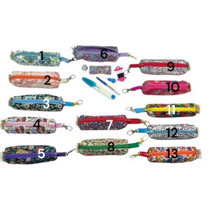 May include: Thirteen small, rectangular fabric zipper pouches with numbered labels, each featuring distinct floral or animal patterns and a metal lobster clasp. Included are sewing accessories: a thimble, a seam ripper, and a thread spool.