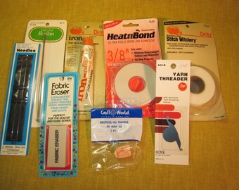 8 sewing tools, 1 pk. 5" needles, 1 6" ball bodkin,1 tube iron off,1 roll HeatnBond,1 Stitch Witchery,fabric eraser, yarn threader,1 thimble