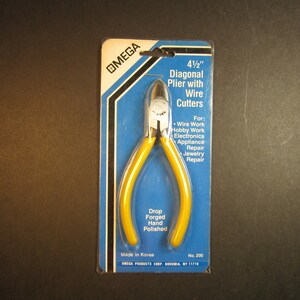 May include: A yellow and silver 4 1/2 inch diagonal pliers with wire cutters on a blue and white package. The package says "OMEGA" and "Drop Forged Hand Polished".