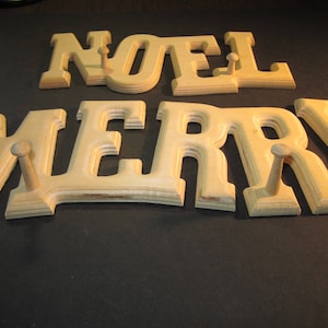 Noel and Merry word plaques, 5" tall letters, with pegs, routed wood, made in USA, vintage stock