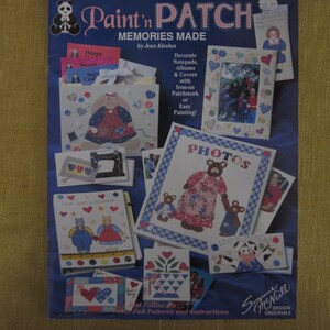 May include: A book cover with a blue background and a title that reads "Paint 'n Patch Memories Made" by Jean Kievlan. The cover features a variety of colorful patchwork designs, including a bear, a bunny, and a sewing machine. The book includes instructions for decorating notepads, albums, and covers with iron-on patchwork or easy painting.