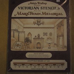 May include: A vintage-style package for Victorian stencils from the Mark Twain Memorial. The package features a drawing of a room with a fireplace, a window, and a screen. The text on the package reads "Adele Bishop Presents Victorian Stencils from the Mark Twain Memorial." The package also includes the text "Arrowhead Border - MT 200" and "Width 5" on pre-cut Mylar."