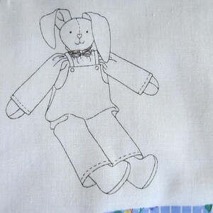 May include: Line drawing of a bunny wearing overalls and a bow tie. The bunny has long ears and is standing with its legs spread apart. The drawing is on a white background.