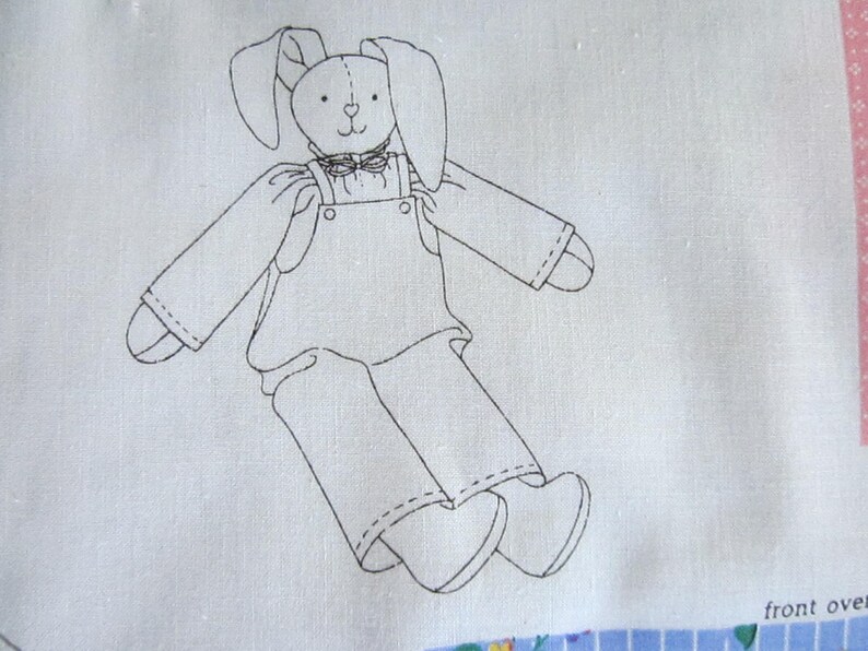 May include: Line drawing of a bunny wearing overalls and a bow tie. The bunny has long ears and is standing with its legs spread apart. The drawing is on a white background.