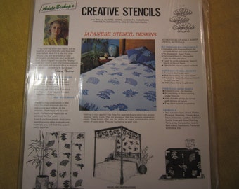 May include: A close-up of a package for Japanese stencil designs. The package features a black and white image of a four-panel screen with a floral design. The text on the package reads "Adele Bishop's Creative Stencils" and "Japanese Stencil Designs".