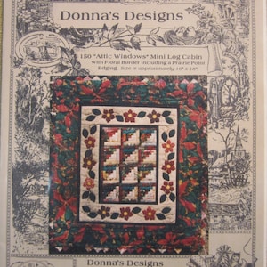 May include: A quilt pattern for a mini log cabin quilt with a floral border. The quilt is approximately 10 inches by 18 inches. The pattern is called "150 "Attic Windows" Mini Log Cabin with Floral Border including a Prairie Point Edging".