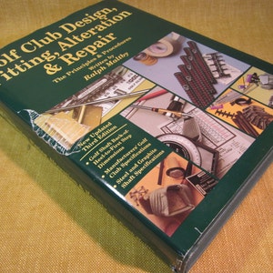 May include: A green hardcover book titled "Golf Club Design, Fitting, Alteration & Repair" with the author's name "Ralph Maltby" and the subtitle "The Principles & Procedures". The book cover features various tools and equipment used in golf club fitting and repair.