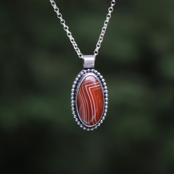 Lake Superior Agate necklace in handmade sterling silver setting, red oval with white stripes