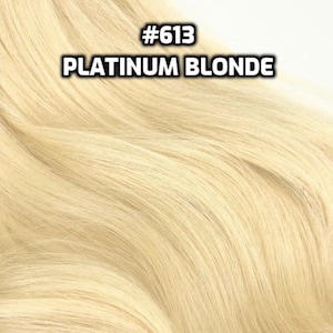 May include: A close-up of platinum blonde human hair extensions. The hair is soft and silky, with a natural wave. #613 Platinum Blonde.
