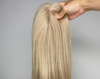 May include: A long, straight, light blonde human hair topper. The hair is very fine and silky.