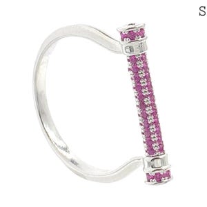 May include: A silver ring featuring a vertical bar element encrusted with small, vibrant pink stones. The design includes a main view and a smaller inset labelled Side View, showing the ring's profile with the pink stone-set bar at the top.