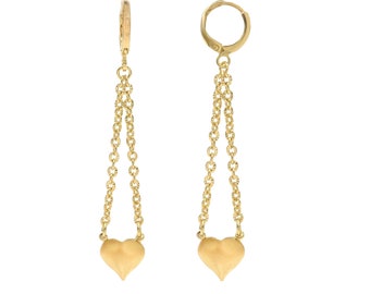 May include: A pair of gold earrings with a heart-shaped pendant hanging from two chains.
