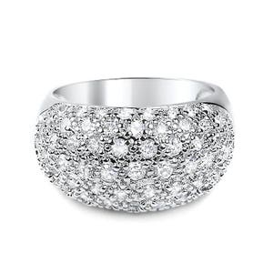 May include: A wide, silver-toned ring encrusted with numerous small, clear gemstones. The ring has a rounded, domed shape, with the gemstones covering the entire surface. The band is smooth and polished, creating a contrast with the textured gemstone surface.