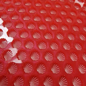 May include: Red silicone baking mould with multiple shell-shaped cavities.