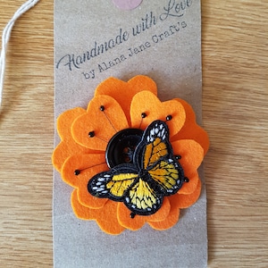Felt flower and buterfly brooch in orange