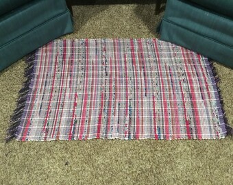 Purple and pink rag rugs, 26 x 43 inches