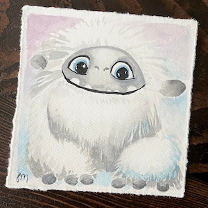 May include: A watercolor painting of a white yeti with blue eyes and a big smile. The yeti is standing on a light blue background.