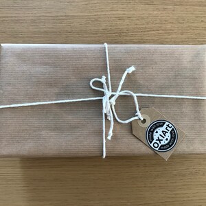 May include: A brown paper package tied with white string and a brown tag that says "OXIAFT made with love made with love".