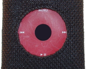 May include: A brown fabric case with a black screen displaying the word "jüt" in orange. The case has a red circular button with a black center and a "MENU" label.