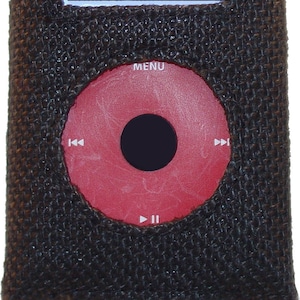 May include: A brown fabric case with a black screen displaying the word "jüt" in orange. The case has a red circular button with a black centre and a "MENU" label.