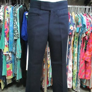 May include: A pair of dark blue, wide-leg pants with a straight fit from the waist to the knee and a slight flare from the knee to the hem.