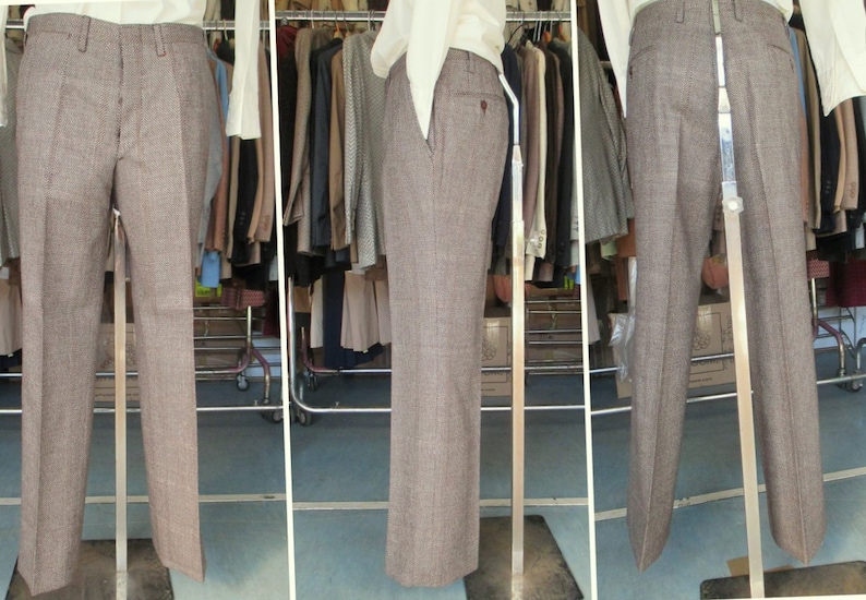 May include: A pair of brown plaid pants on a mannequin. The pants have a straight leg and a classic fit.