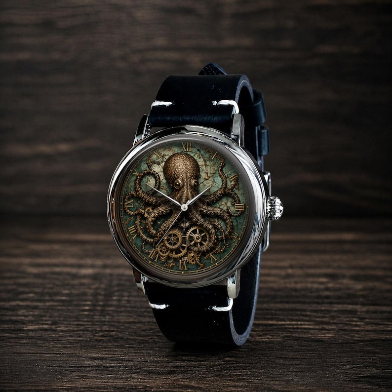 May include: A round wristwatch with a black leather band. The watch face features a detailed illustration of an octopus with gears and Roman numerals. The watch has a silver-colored case and a black leather strap.