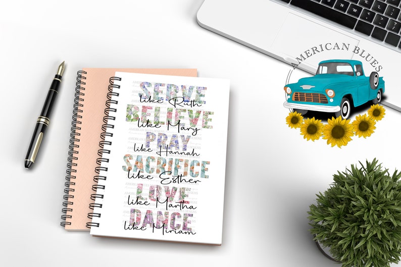 May include: Two spiral-bound notebooks, one peach and one white, with a black pen on a white surface. The white notebook features floral text that reads "SERVE like Ruth, BELIEVE like Mary, PRAY like Hannah, SACRIFICE like Esther, LOVE like Martha, DANCE like Miriam."