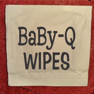 May include: A white package of Baby-Q wipes. The package is rectangular and has a white background with black text.