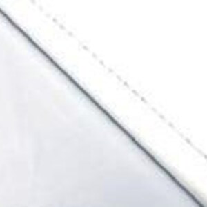 May include: White fabric with a stitched edge. The fabric is smooth and appears to be a plain weave.