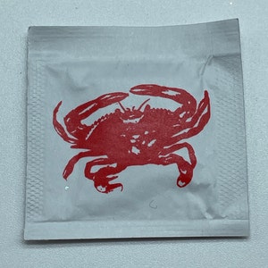 Crab Wet Wipes, stock design crab is printed onto one side of a moist towelette packet for crab feeds, fests & feasts, minimum 25 packets
