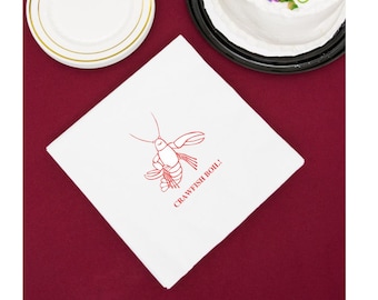 May include: White cloth napkin with a red crawfish illustration and the text "Crawfish Boil!" printed on it.