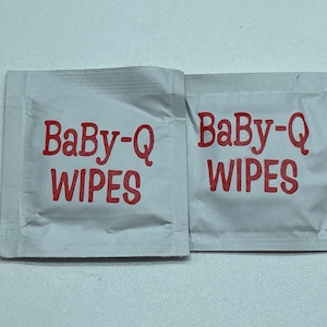 May include: Two white Baby-Q wipes packets with red text.