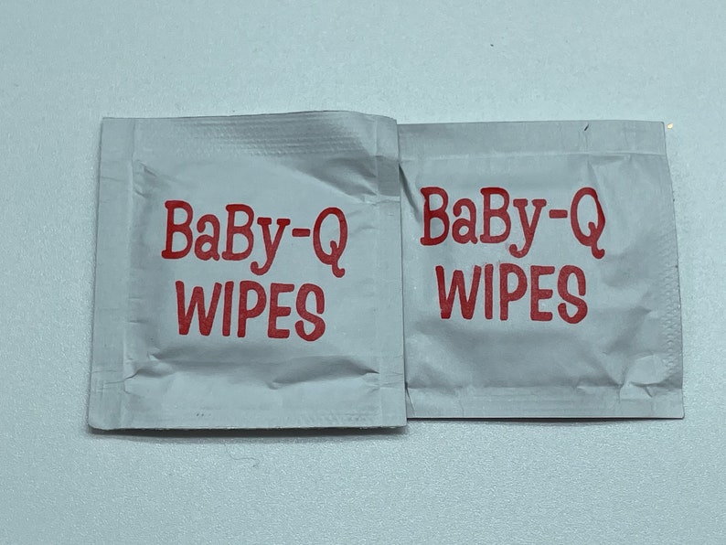 May include: Two white Baby-Q wipes packets with red text.