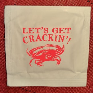 Let's Get Crackin' Wet Wipes, stock design is printed onto one side of a moist towelette packet for crab feeds & feasts, minimum 25 packets