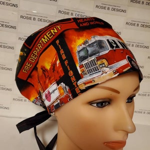 May include: A red, black, and yellow surgical scrub hat with a fire truck and the words "Fire Department" and "Fire Fighters".